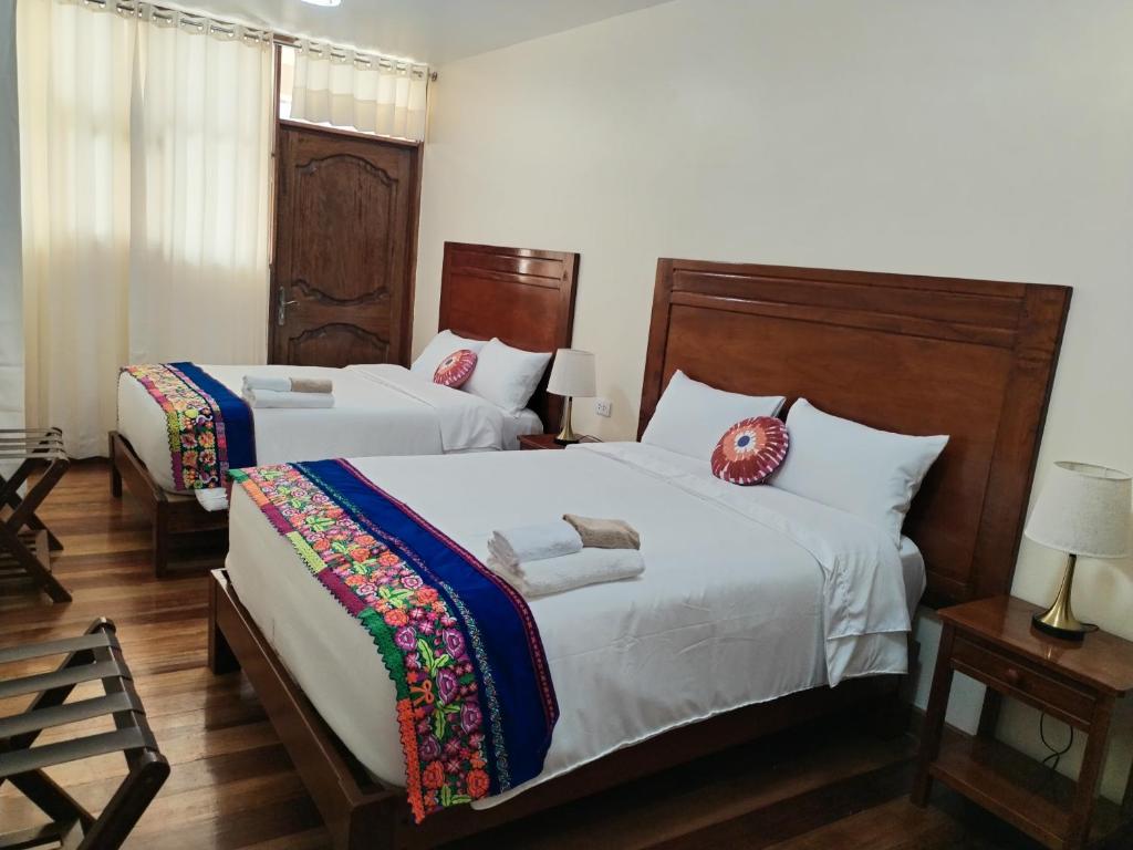 Postel nebo postele na pokoji v ubytování NUNA SUMAQ Hotel