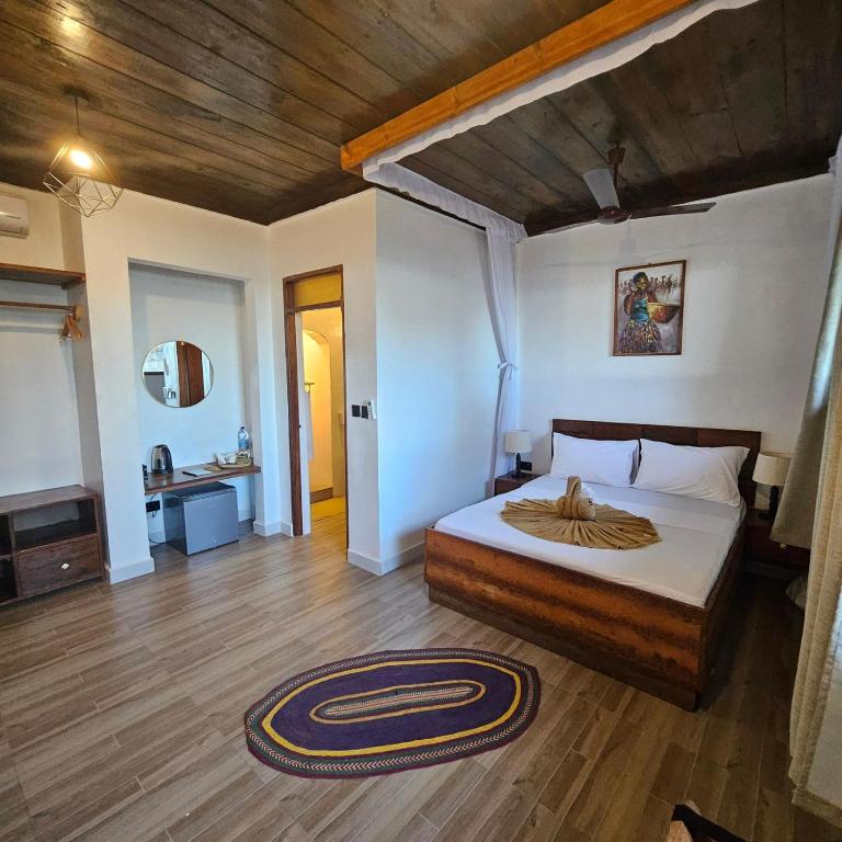 Postel nebo postele na pokoji v ubytování Mambo Ocean Resort