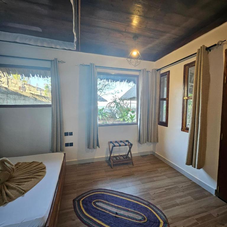 Postel nebo postele na pokoji v ubytování Mambo Ocean Resort