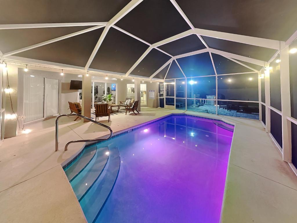 a swimming pool in a house with a ceiling at Shore Thing in Palm Coast