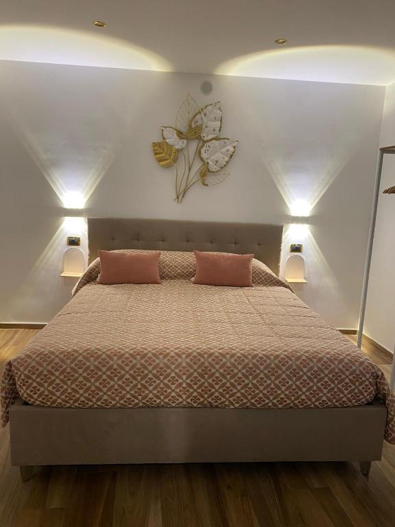 a bedroom with a bed with two pillows on it at La casa di nonna chella in Bari