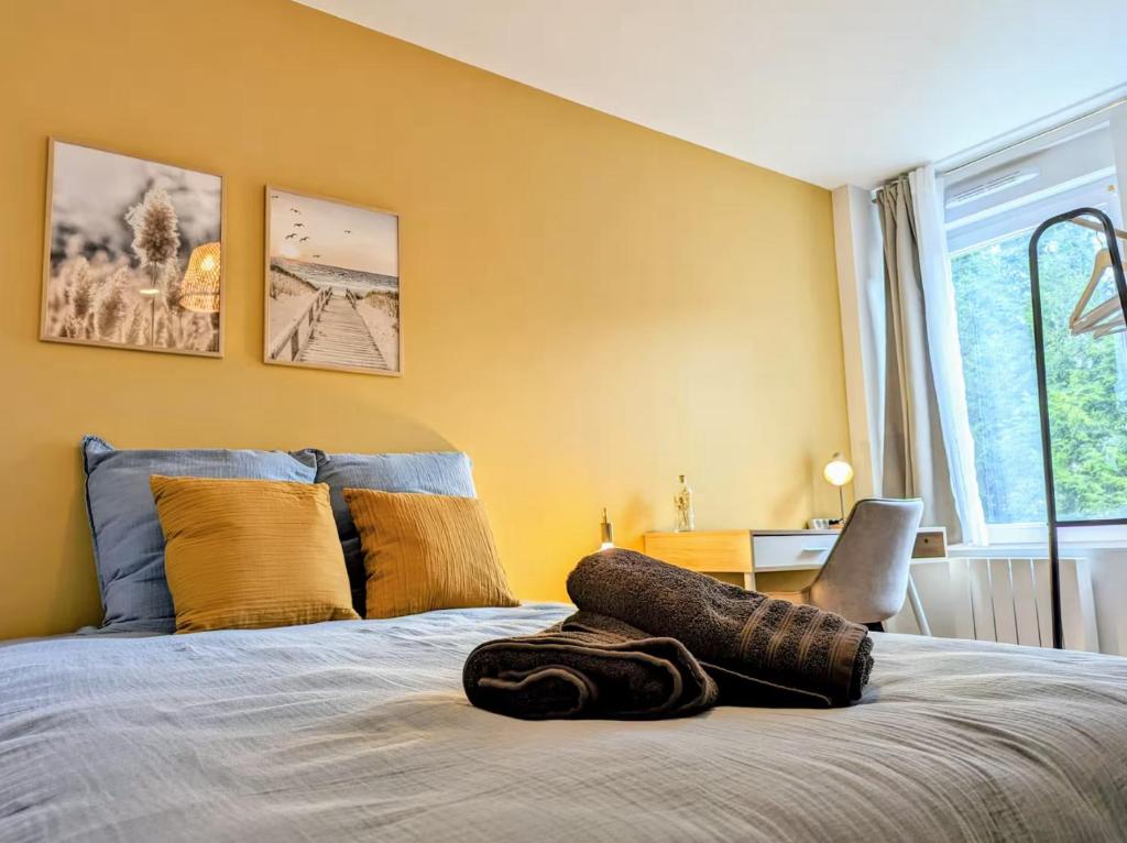 a bedroom with a bed with a pillow on it at L'apostrophe - Duplex et terrasse in Douai