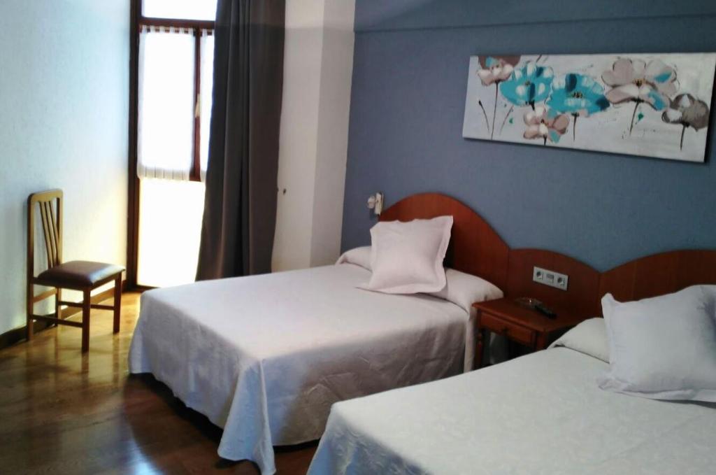 Postel nebo postele na pokoji v ubytování Hotel Urgaín