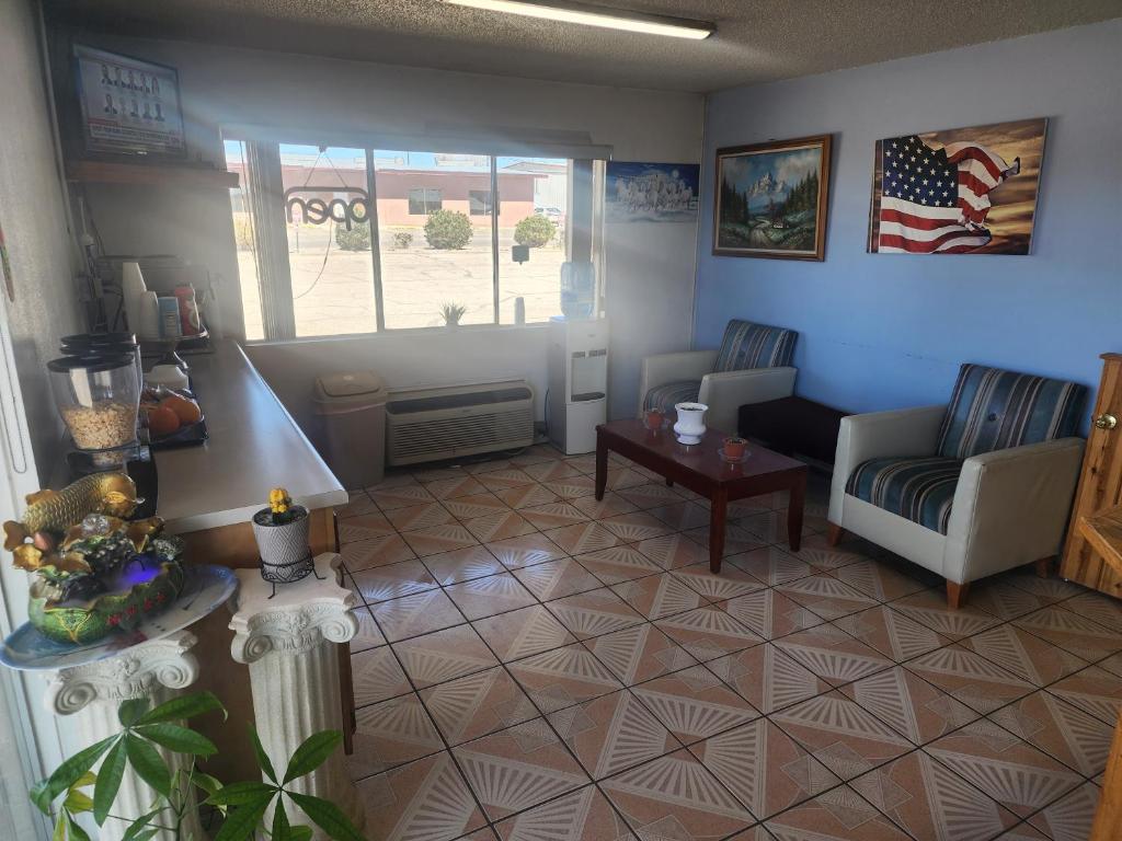 a living room with a couch and a table at Satellite Inn in Alamogordo