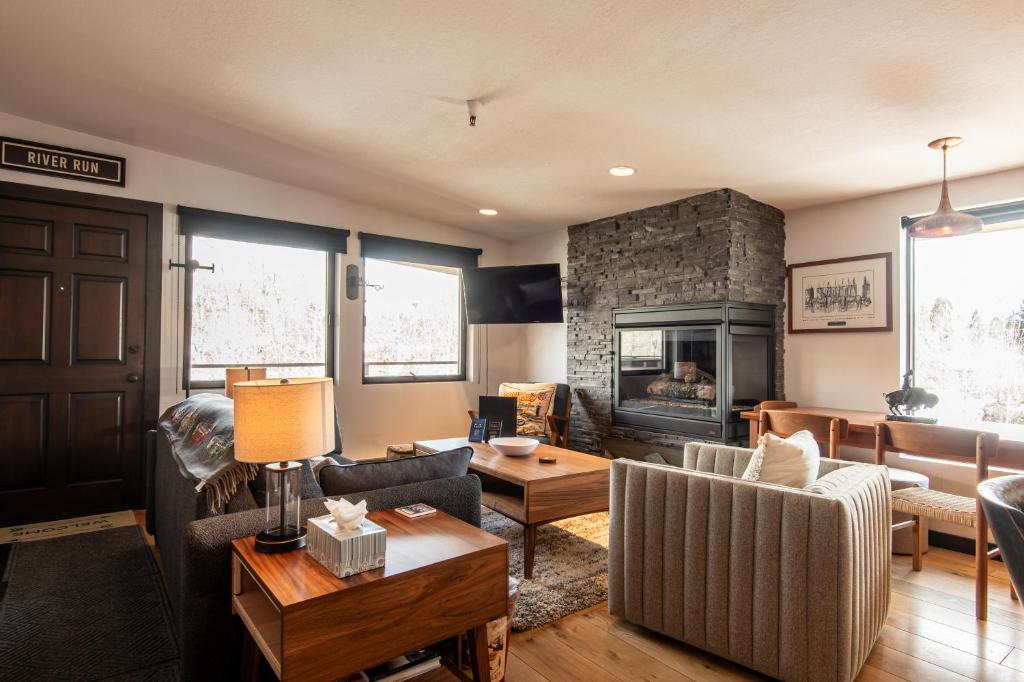 a living room with a couch and a fireplace at Christophe Condo 712 in Ketchum