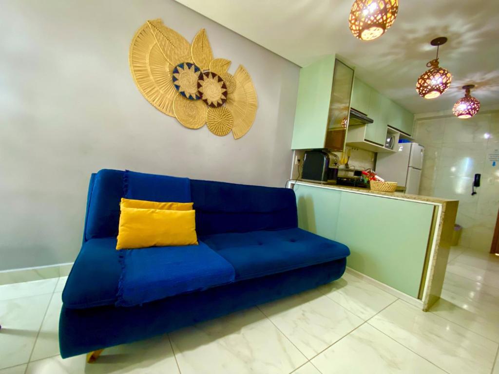 a blue couch with a yellow pillow in a kitchen at Flat premium centro de Porto de Galinhas-Makambira Residence-Flat309 in Porto De Galinhas
