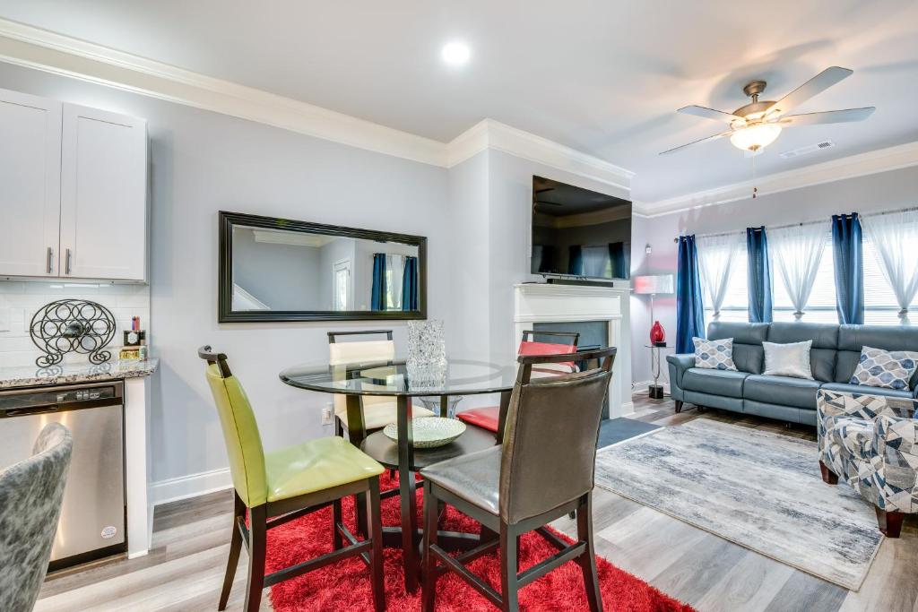 a dining room and living room with a table and chairs at Atlanta Home with Patio, 8 Mi to Downtown and Aquarium in Atlanta