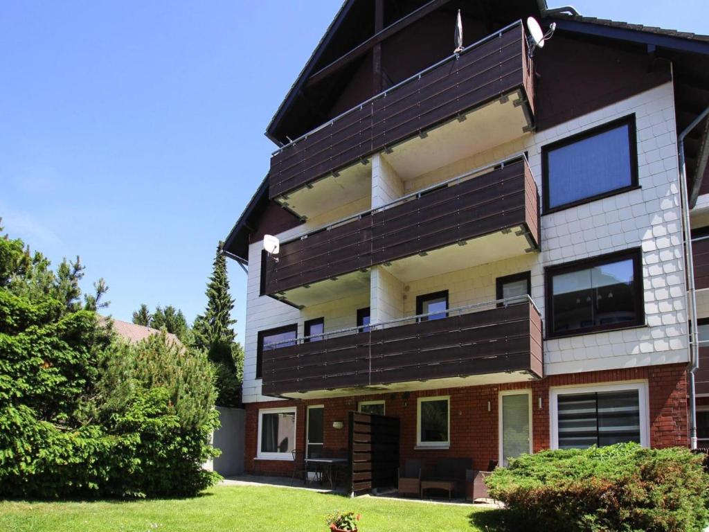 a building with black balconies on the side of it at Ferienwohnung Zauberhexe in Braunlage in Braunlage