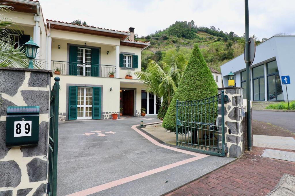 a house with a gate in front of a street at Villa Rose by AnaLodges in São Vicente