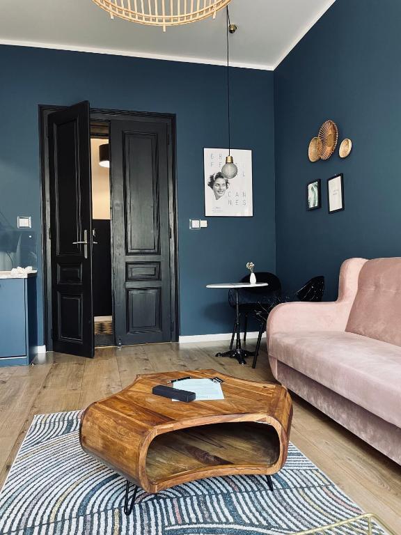 a living room with a couch and a coffee table at Rost Apartments in Bielsko-Biała