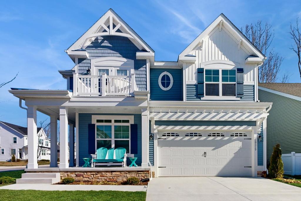 a blue and white house with a garage at Arbor-Lyn --- 19319 Loblolly Cir. in The Plantations