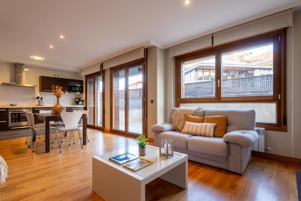 a living room with a couch and a table at Miracielos in Barro de Llanes