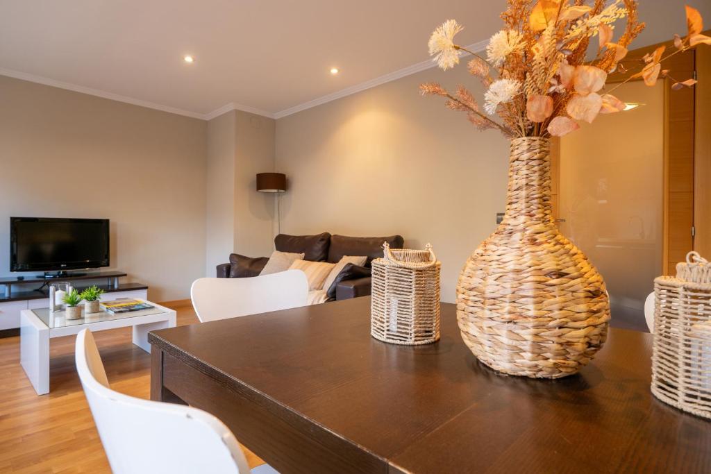 a living room with a table with a vase on it at Miracielos in Barro de Llanes