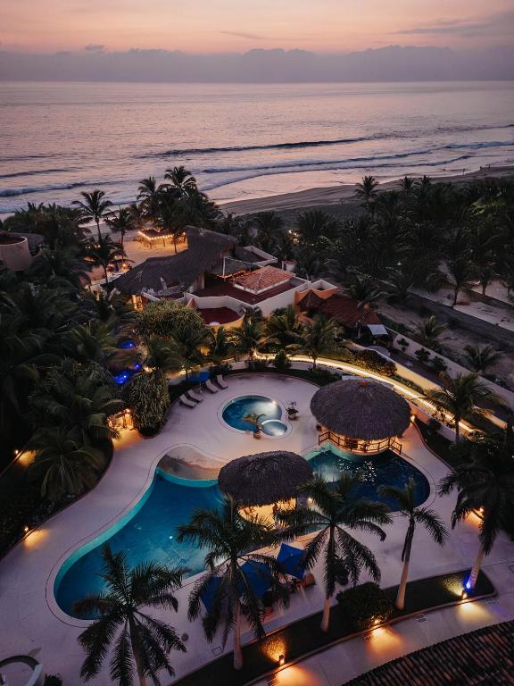 an aerial view of a resort with a swimming pool at Escondite condominios in Zihuatanejo