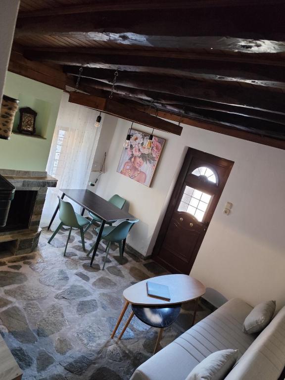 a living room with a table and chairs and a couch at Zagora MGHouse in Zagora
