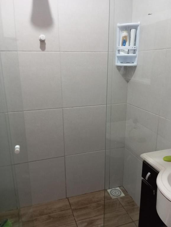 a bathroom with a glass shower with a toilet at Casa na praia do cassino in Rio Grande