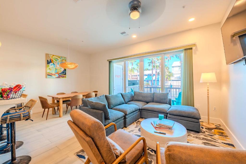 a living room with a blue couch and a table at Starfish Shores in South Padre Island