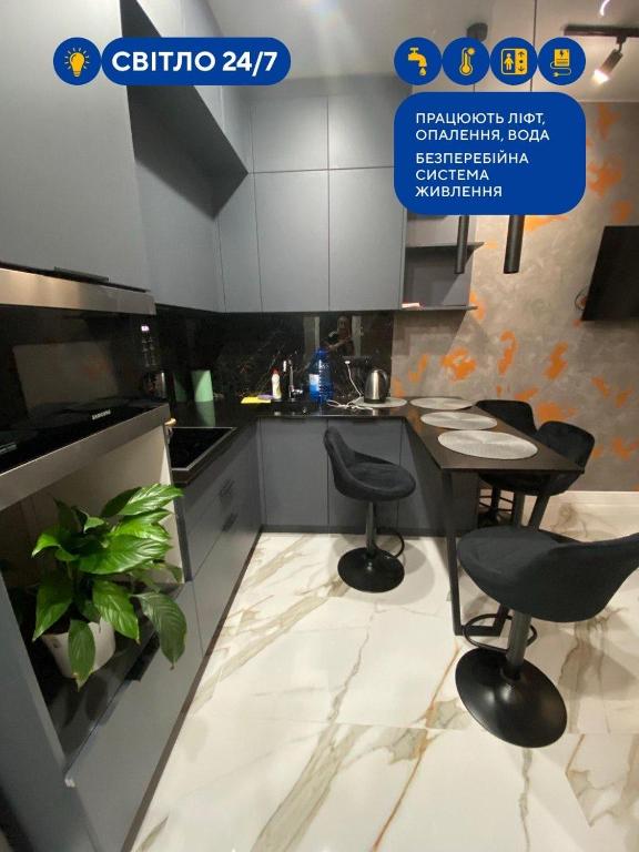 a kitchen with a table and chairs in it at СВІТЛО ЦІЛОДОБОВО Rent-Kiev metro Chernigivska ViP in Kyiv