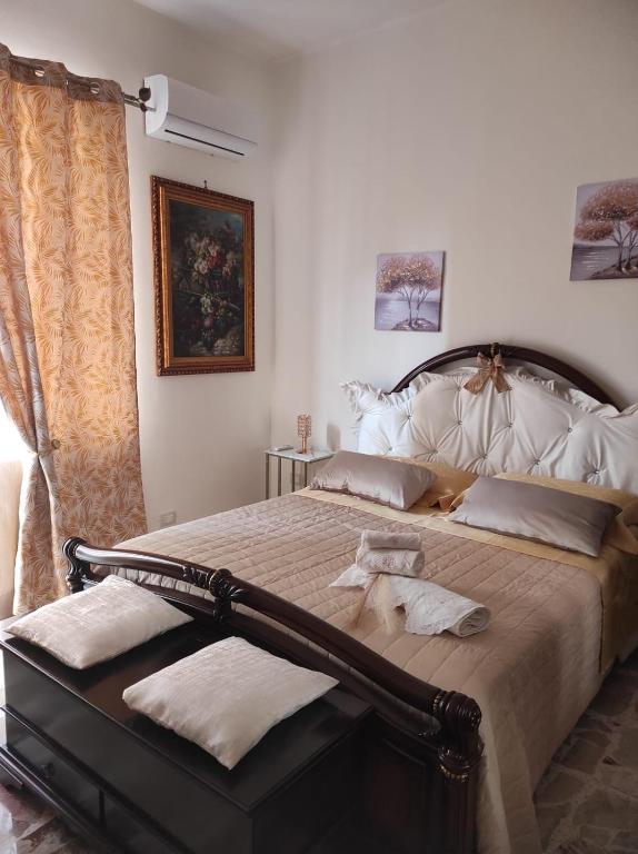 a bedroom with a large bed with towels on it at Medea in Floridia