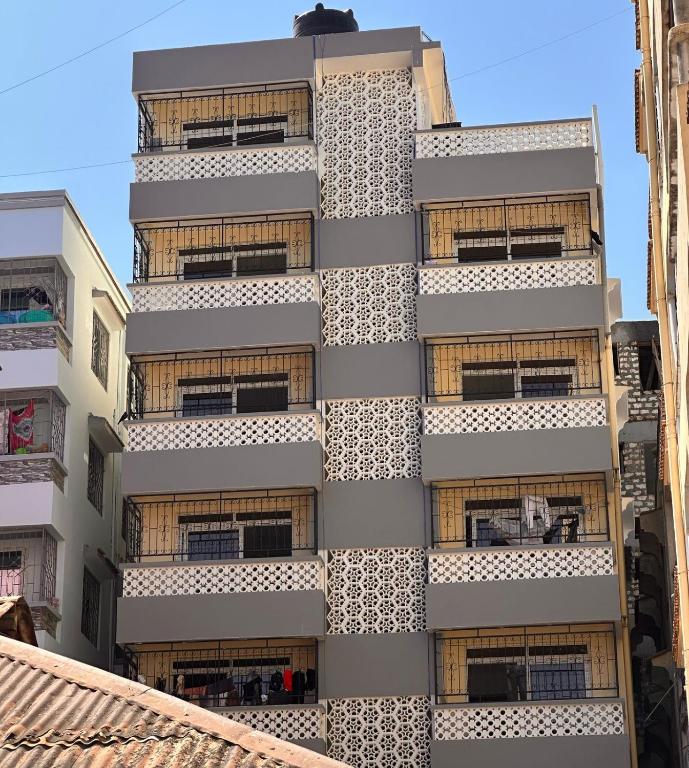 an external view of a building with windows at Harmony Apartments in Mombasa