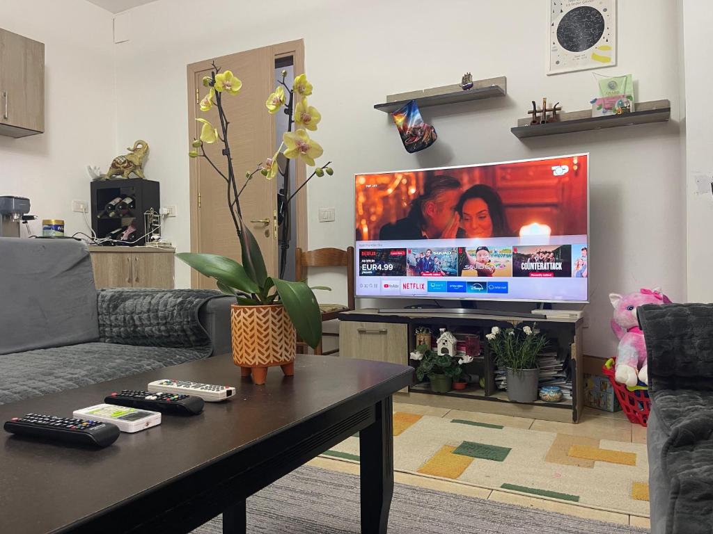 a living room with a couch and a tv at Arteg Apartments - Delux in Durrës