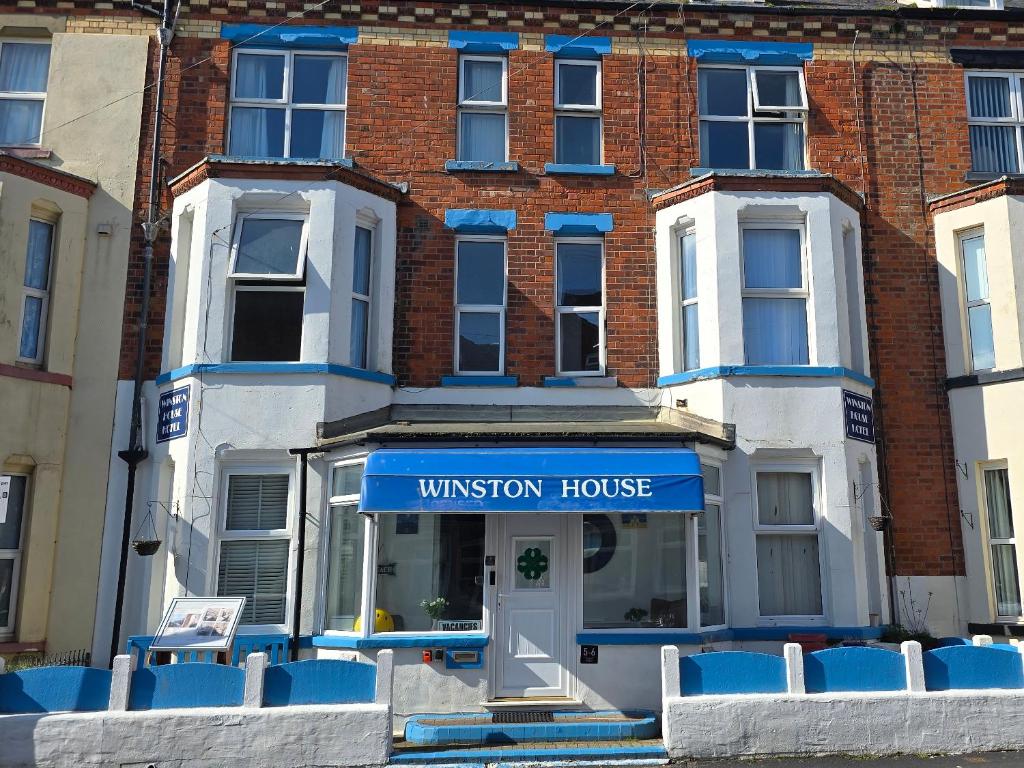 a building with a sign for a museum house at Winston House Guesthouse in Bridlington