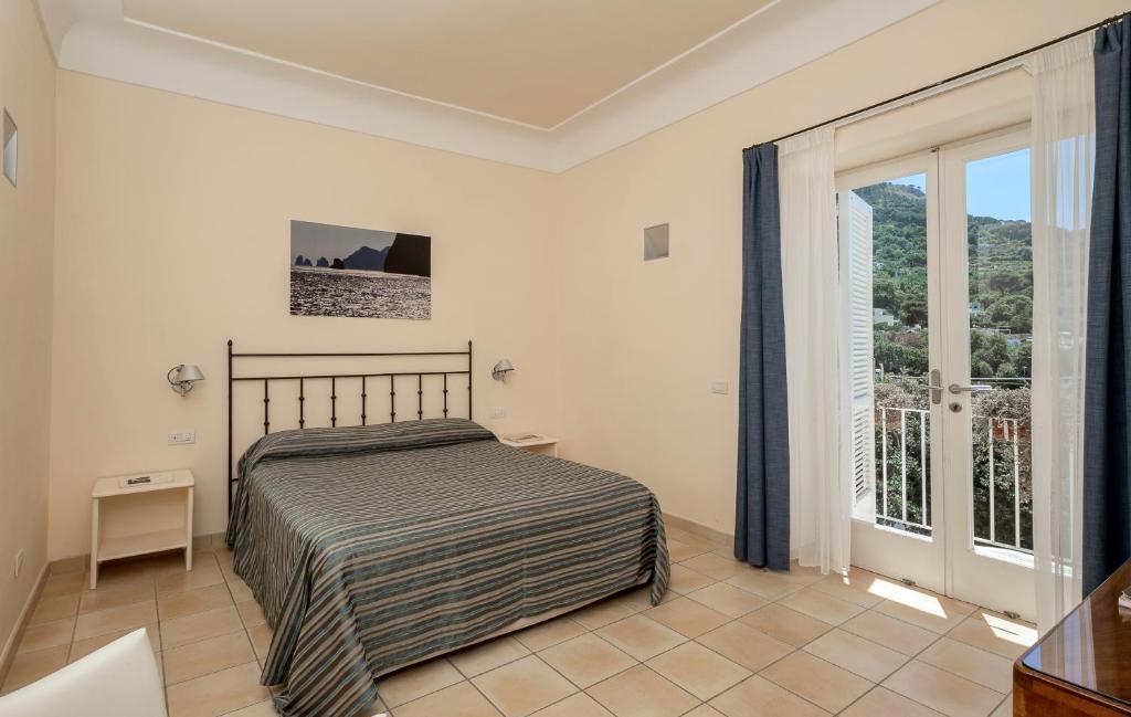 Postel nebo postele na pokoji v ubytování Hotel Senaria