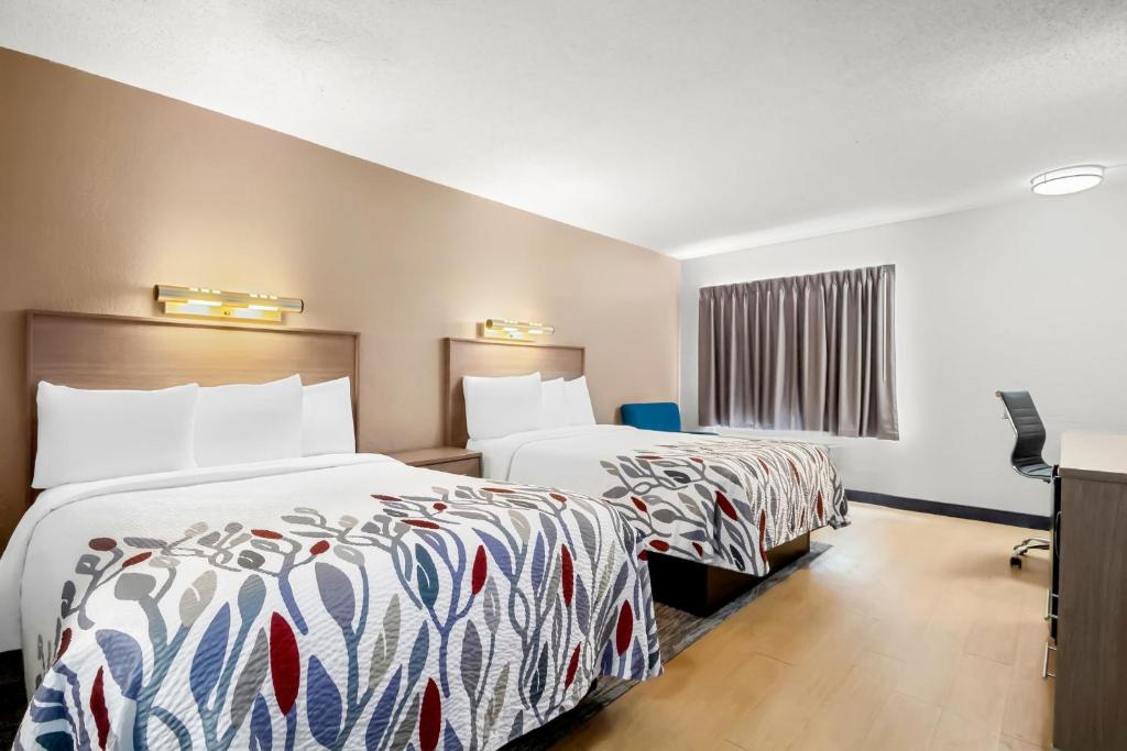 a hotel room with two beds and a window at Red Roof Inn Myrtle Beach Hotel - Market Commons in Myrtle Beach
