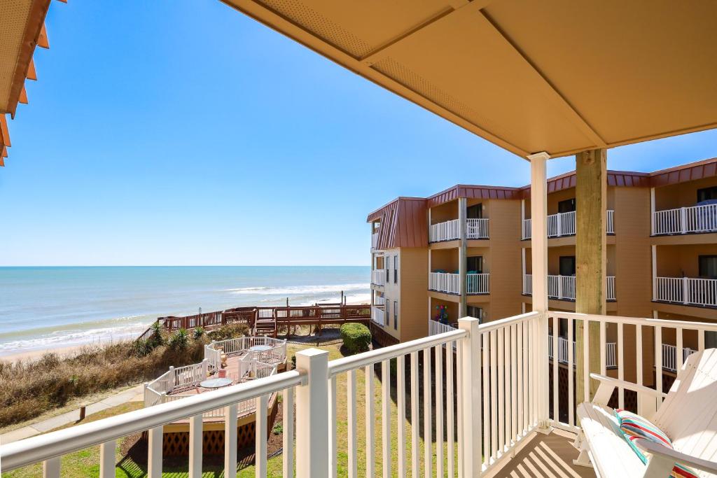 a view of the beach from the balcony of a condo at Oceanfront Bliss at Wave Raider -Perfect Getaway in North Topsail Beach