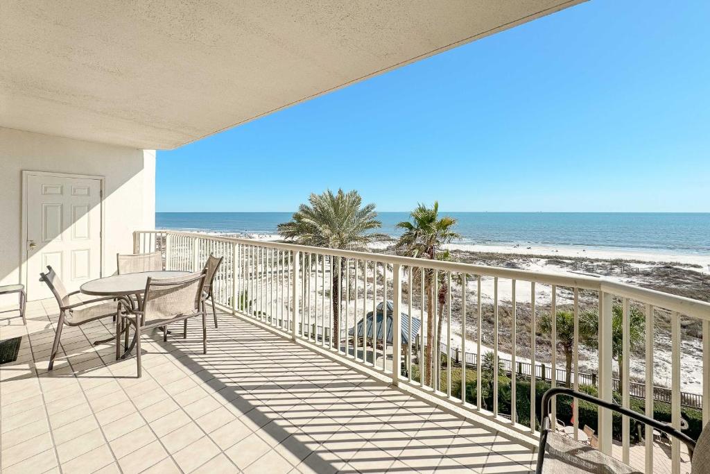 a balcony with a table and chairs and the beach at Beach Club D-506 Beachfront-Tons of Amenities-3-Restaurants-Incredible Views in Gulf Shores
