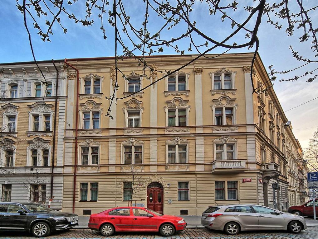 a large building with cars parked in front of it at Apartment Na Kozacce 6 in Prague