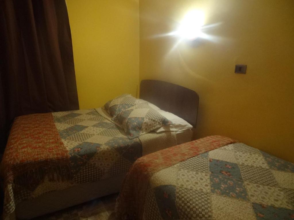 Postel nebo postele na pokoji v ubytování Hostal Kirckir