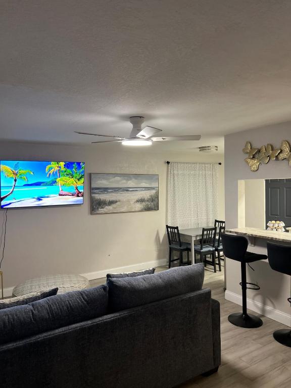 a living room with a couch and a table with chairs at City and Stadium Sanctuary Vibes in Orlando