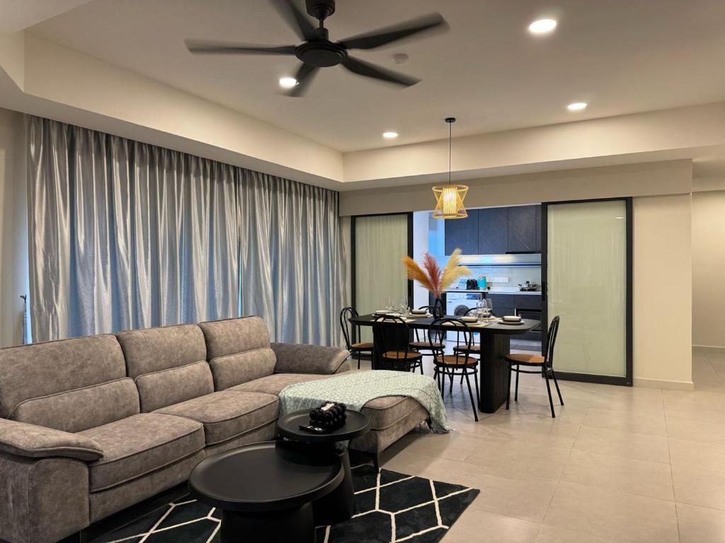 a living room with a couch and a dining room at The Atrium at Jalan Ampang by OKBnB - Classy 3Bedroom Family Suite nearby KLCC , TRX and Pavilion KL in Kuala Lumpur