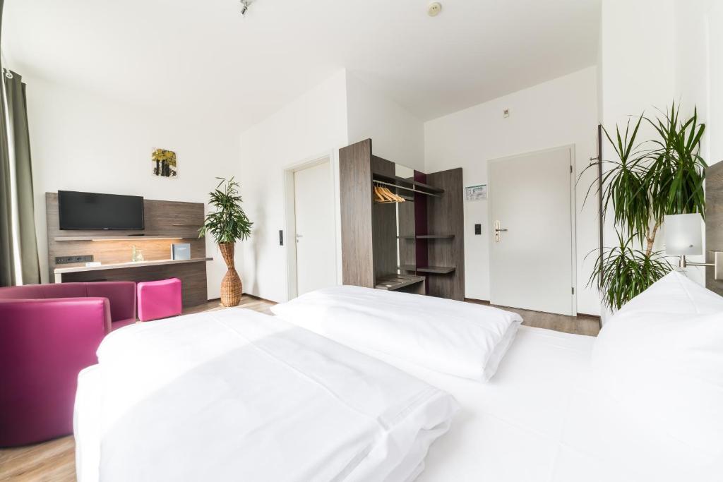 Postel nebo postele na pokoji v ubytování ArtHotel City