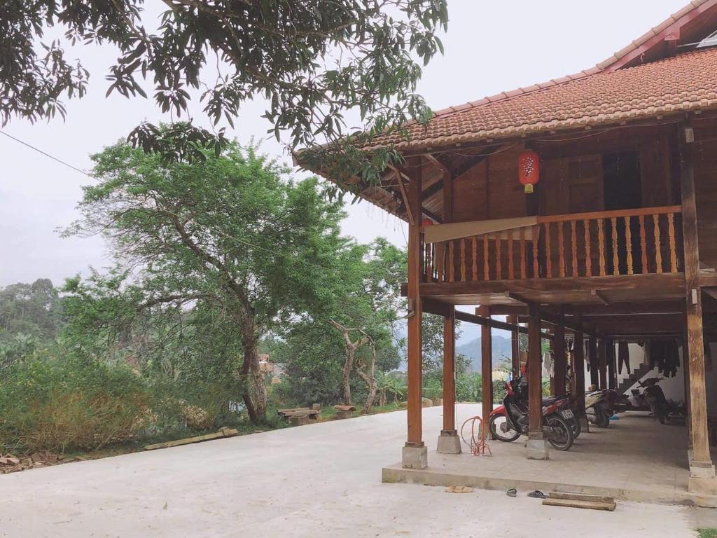 a house with a motorcycle parked in front of it at Hà Giang Homestay in Lan Hung