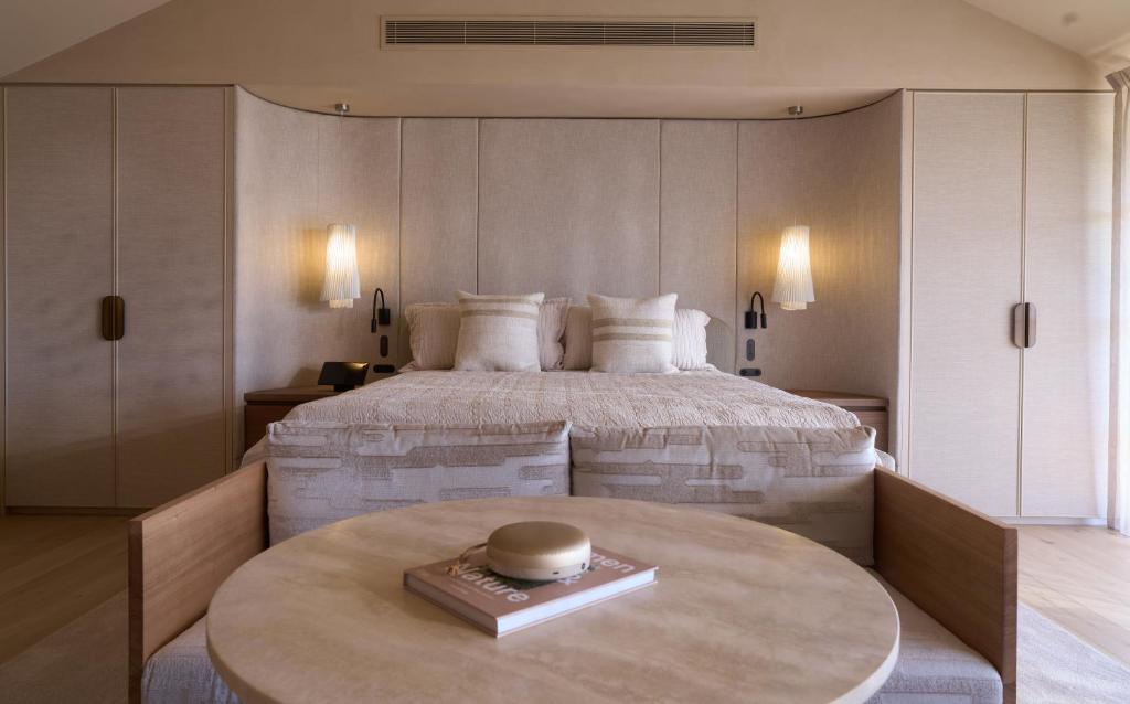 a bedroom with a large bed and a table at The Sanctuary at Alba Thermal Springs & Spa in Fingal