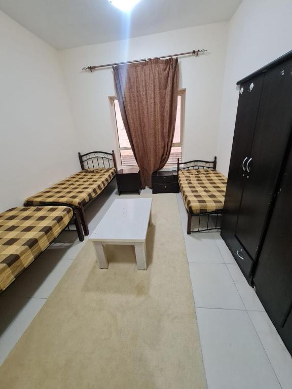 Postel nebo postele na pokoji v ubytování سكن شباب بالتعاون - ALEX Hostel - Sharjah