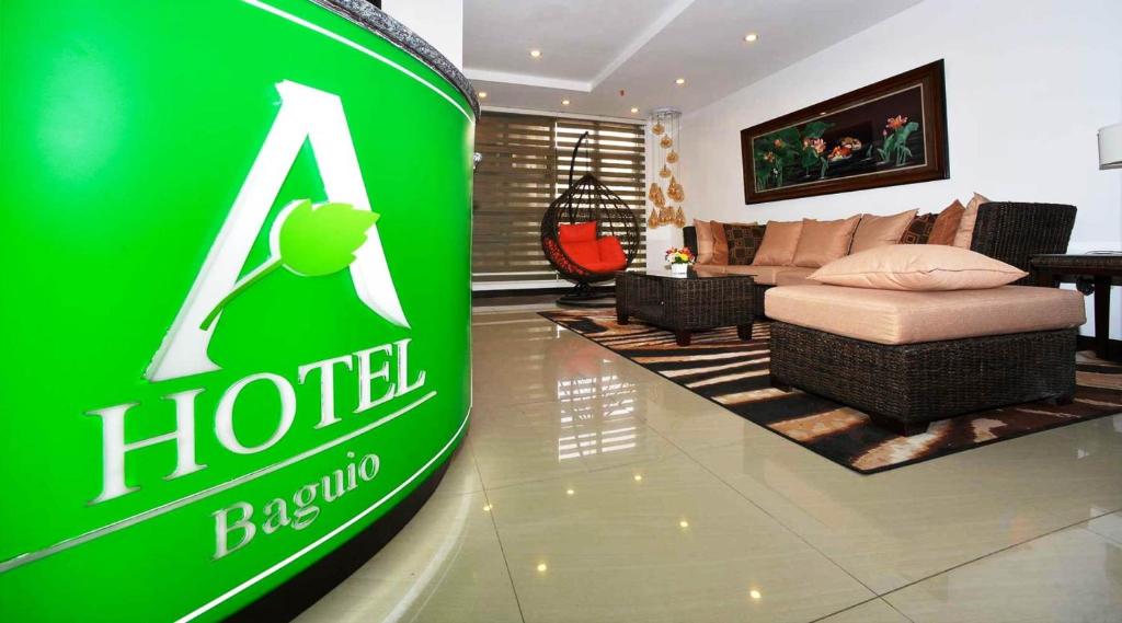 a green hotel sign in a living room at A Hotel Baguio in Baguio