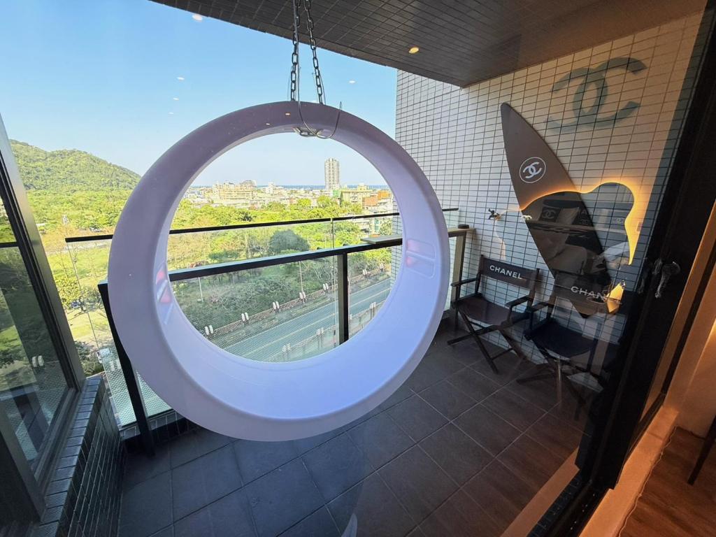 a large circular mirror in a room with a view at 光嶼海溫泉海景無邊際泳池豪華套房 in Hsin-hsing