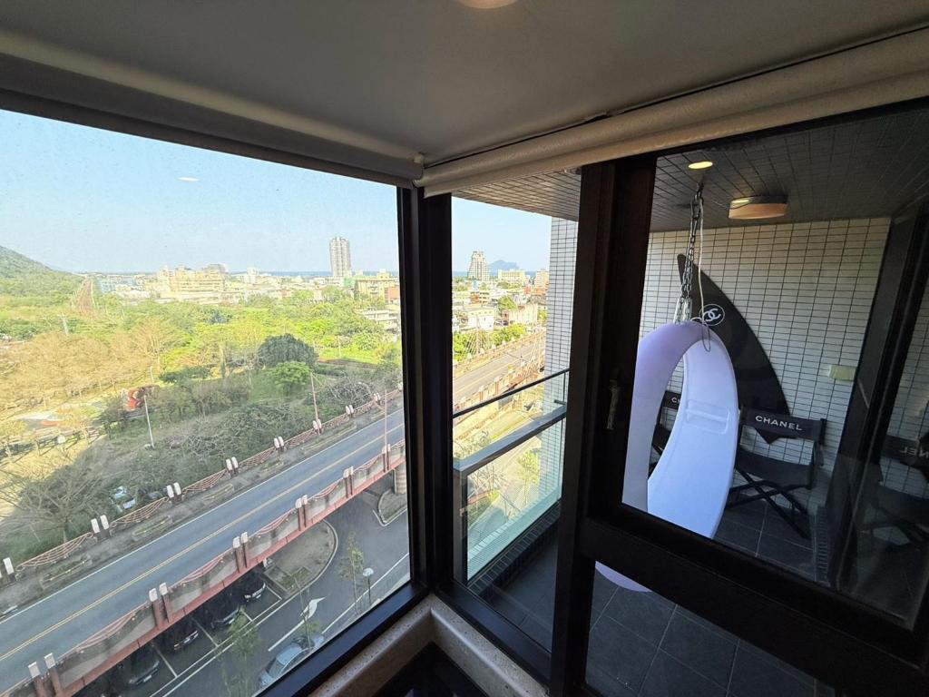 a room with two windows with a view of a train at 光嶼海溫泉海景無邊際泳池豪華套房 in Hsin-hsing