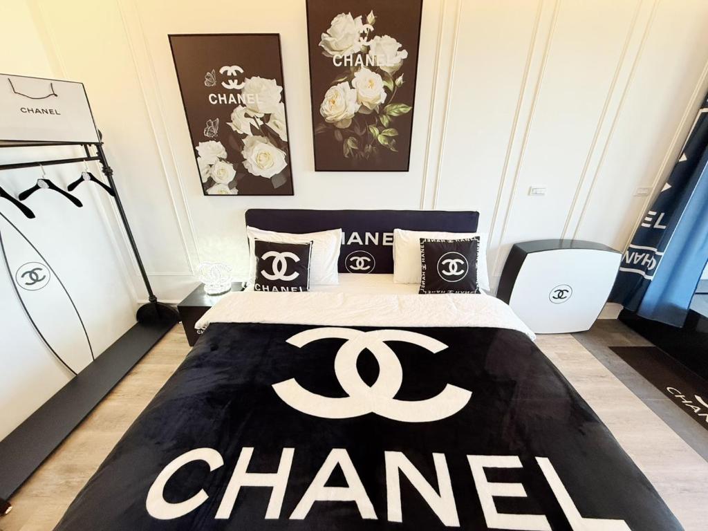 a bedroom with a bed with a chanel sign on it at 光嶼海溫泉海景無邊際泳池豪華套房 in Hsin-hsing