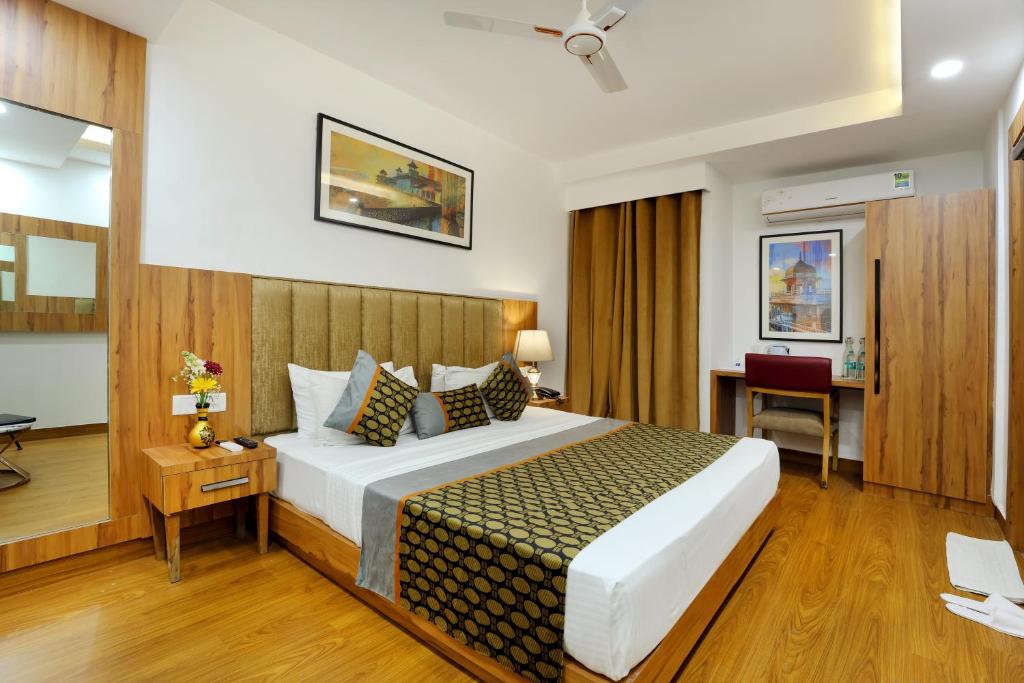 a bedroom with a large bed in a room at OPO Premier, GK2 in New Delhi