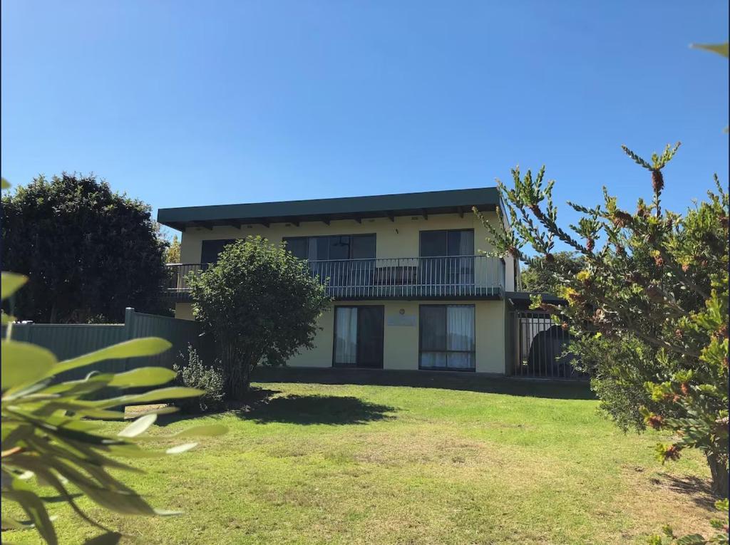 a house with a yard in front of it at Oli's at 57 Lakeside Drive, Mallacoota in Mallacoota