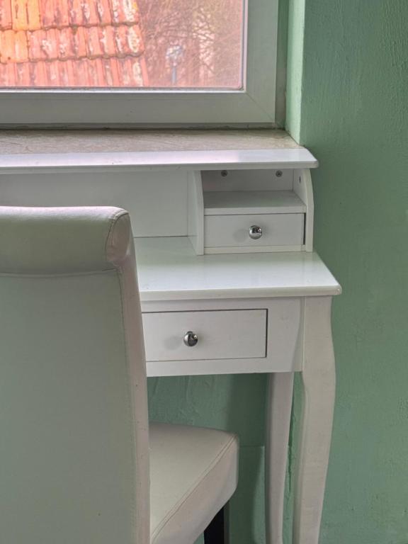 a white desk with a window and a white chair at Farm Privatzimmer Gina Free WiFi in Hausbreitenbach
