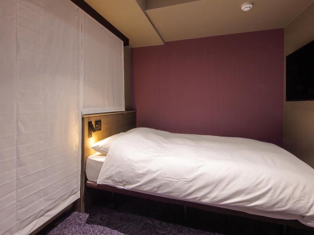Postel nebo postele na pokoji v ubytování Hotel SUI Kobe Sannomiya by ABEST