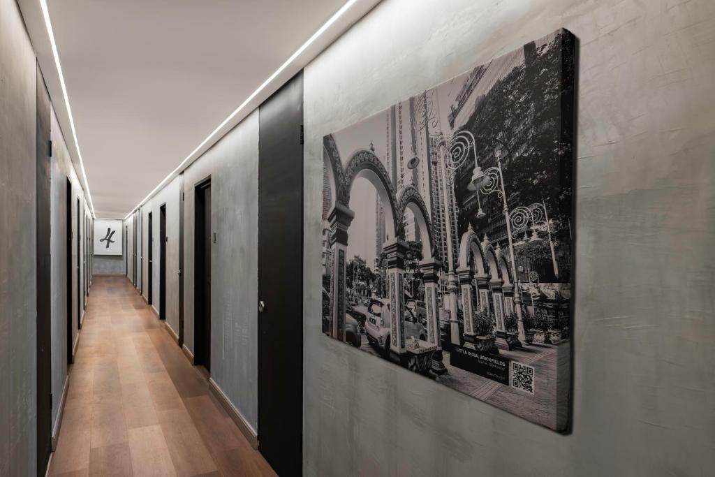 a hallway with black and white posters on the walls at BRYQS Hotel KL Sentral in Kuala Lumpur