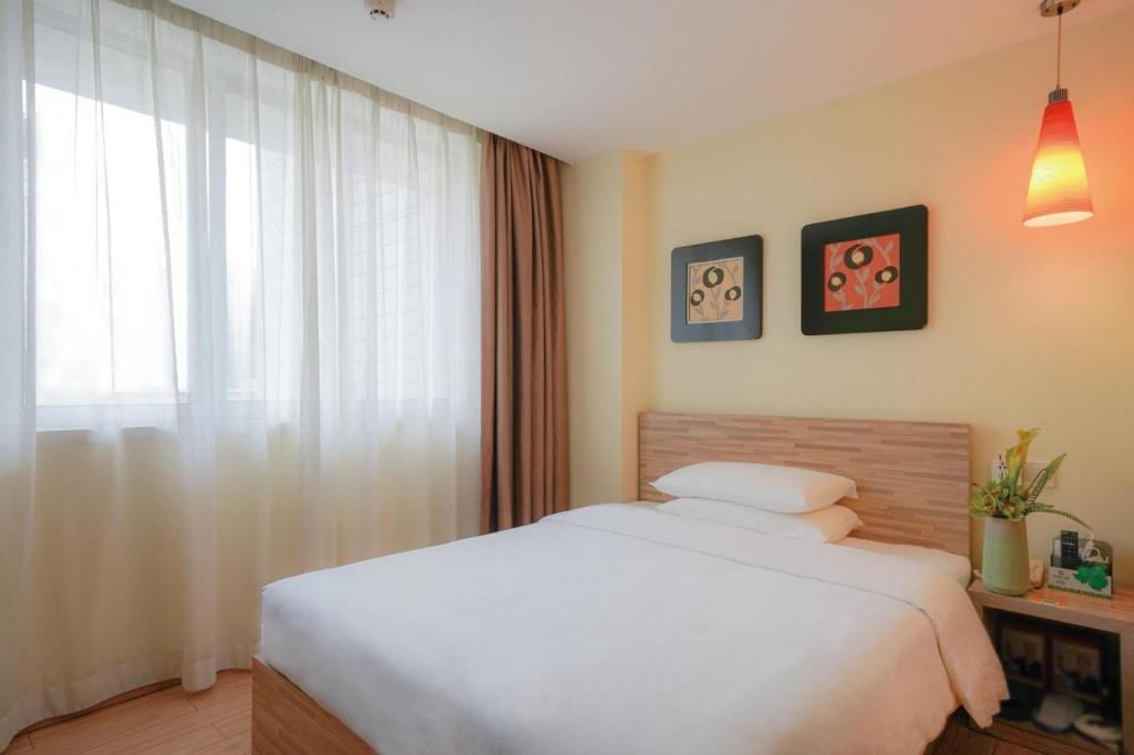 Postel nebo postele na pokoji v ubytování Guangdong Baiyun City Hotel