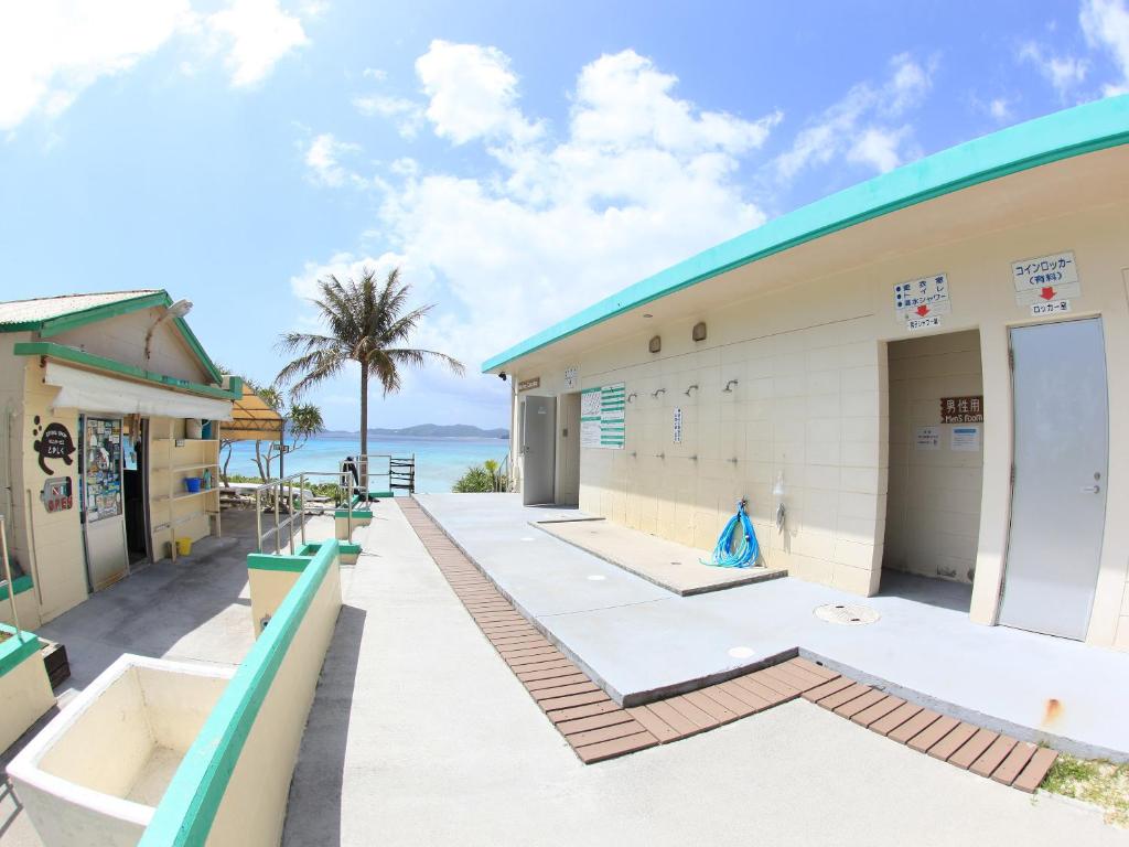 a building with the ocean in the background at Tokashiku Marine Villege in Tokashiki