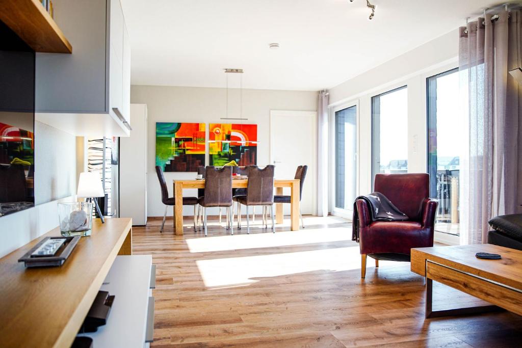 a living room with a table and a dining room at FeWo Siebenstern in Winterberg
